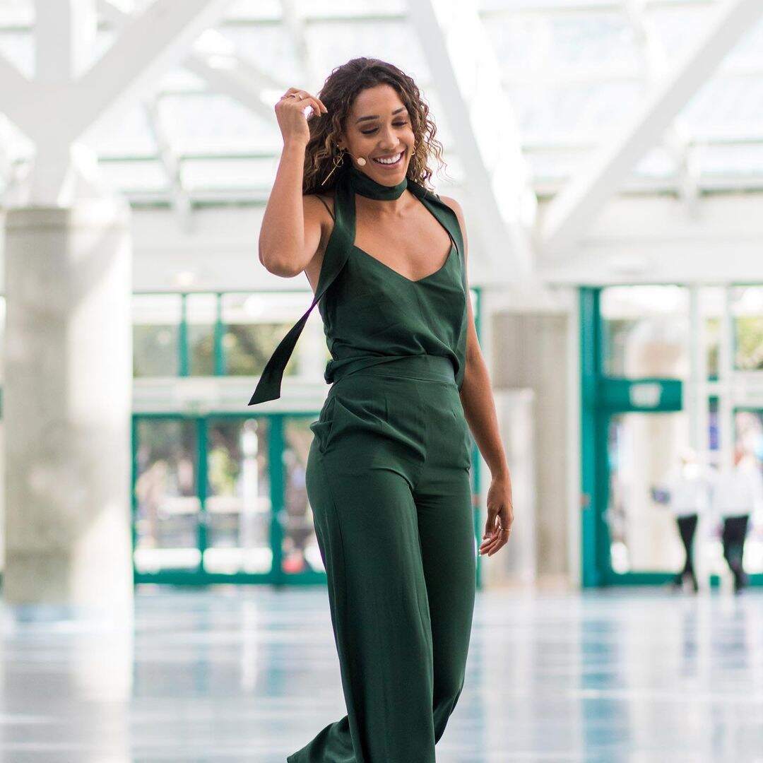 Simone Boyce smiling in a green dress 